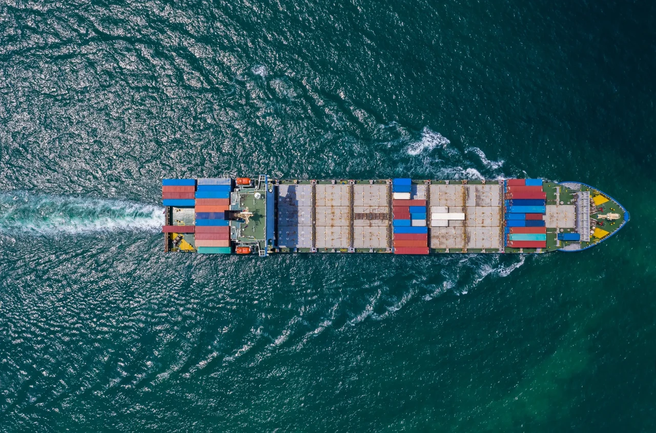 Shipping cargo containers transportation import export International business services open sea aerial top view from drone.